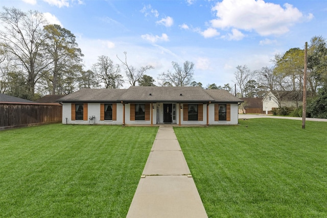 view of front of house featuring a front yard, fence, and driveway