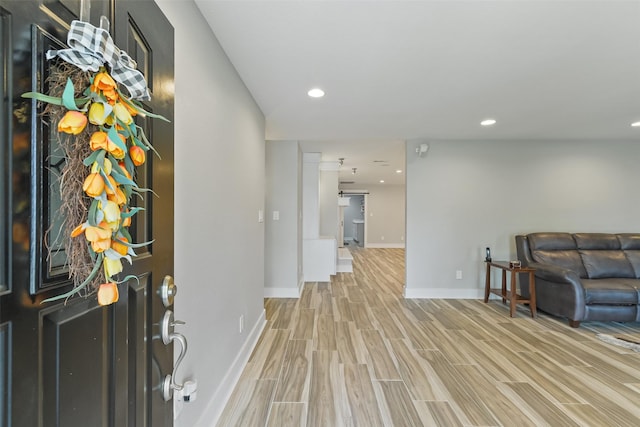 entrance foyer with wood finish floors, baseboards, and recessed lighting