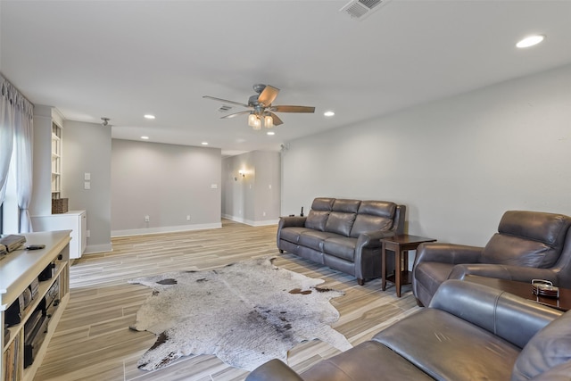 living room with recessed lighting, visible vents, light wood-style flooring, and a ceiling fan