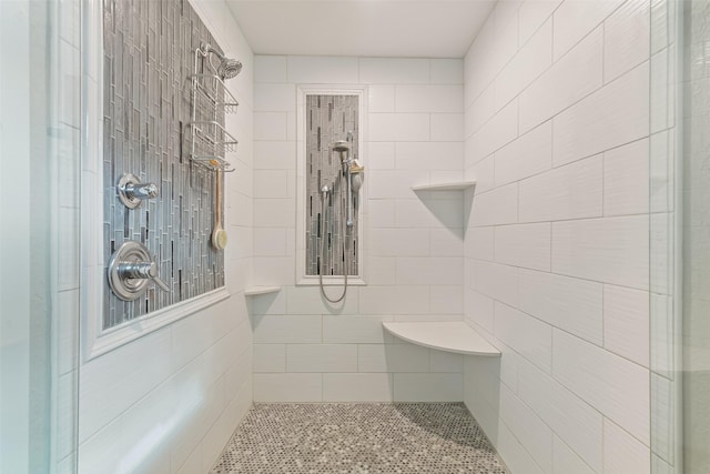 bathroom with tiled shower