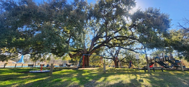 view of yard with fence and playground community