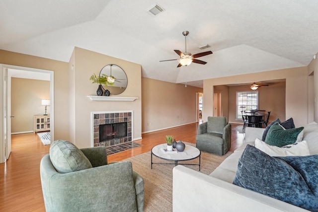 living area with wood finished floors, visible vents, and ceiling fan