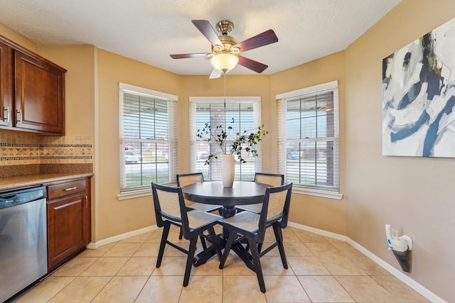 dining room with plenty of natural light, baseboards, and light tile patterned floors