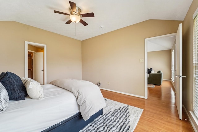 bedroom with light wood-type flooring, baseboards, ceiling fan, and vaulted ceiling