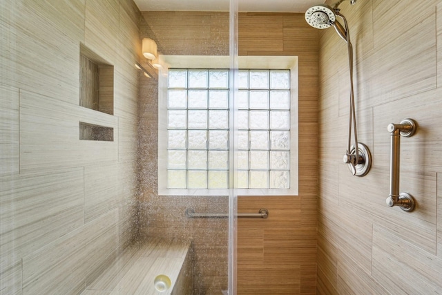 full bath featuring a tile shower