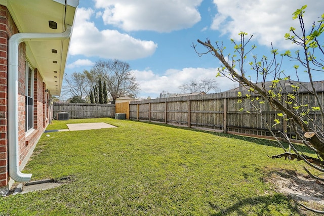 view of yard featuring a patio area, a fenced backyard, and central AC