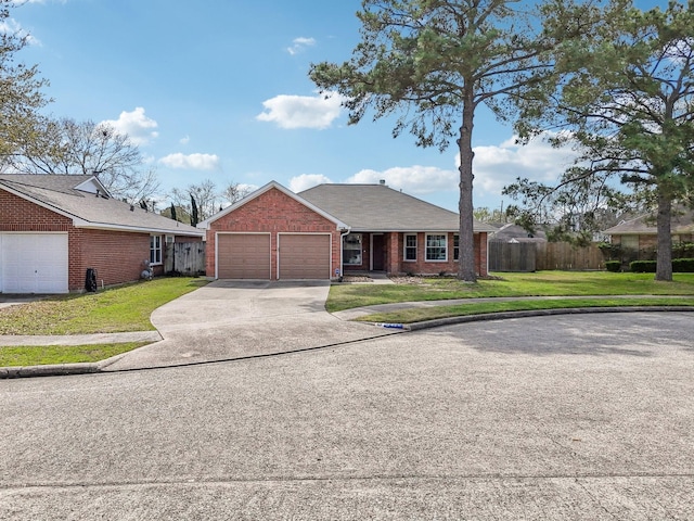 single story home with a garage, brick siding, a front yard, and fence