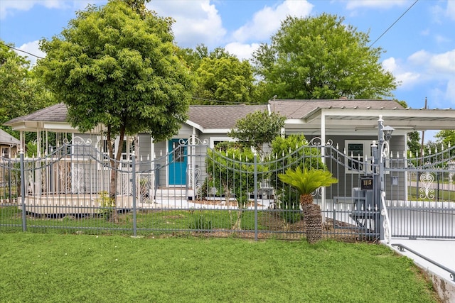 view of front of home with a fenced front yard, roof with shingles, a front yard, and a gate