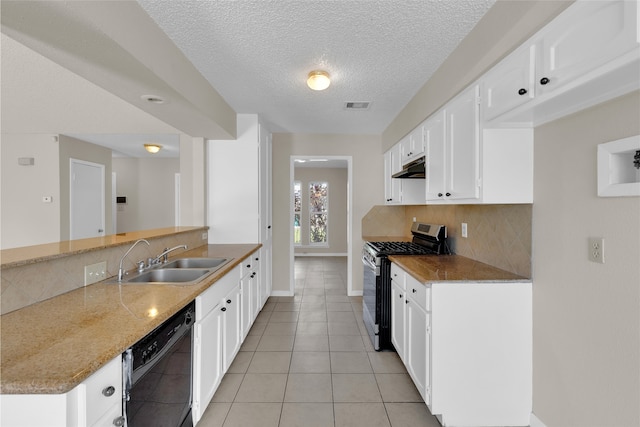 kitchen with visible vents, under cabinet range hood, black dishwasher, stainless steel gas range, and a sink