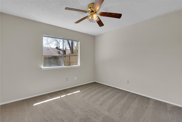 unfurnished room with a ceiling fan, baseboards, a textured ceiling, and carpet flooring