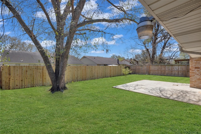 view of yard featuring a patio area and a fenced backyard