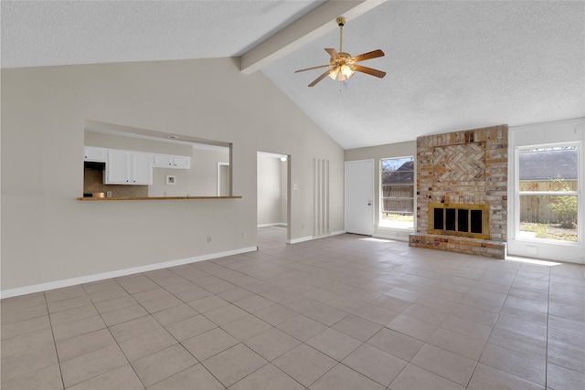 unfurnished living room featuring light tile patterned floors, beamed ceiling, a textured ceiling, and ceiling fan