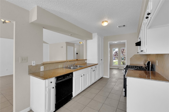 kitchen featuring visible vents, stainless steel range with gas cooktop, black dishwasher, decorative backsplash, and a sink