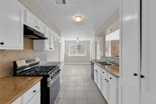 kitchen with dishwashing machine, visible vents, stainless steel gas range, a sink, and under cabinet range hood