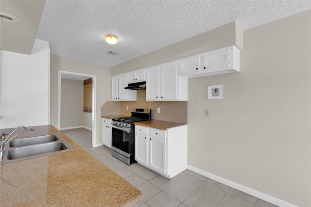 kitchen featuring a sink, decorative backsplash, under cabinet range hood, stainless steel gas range oven, and white cabinetry