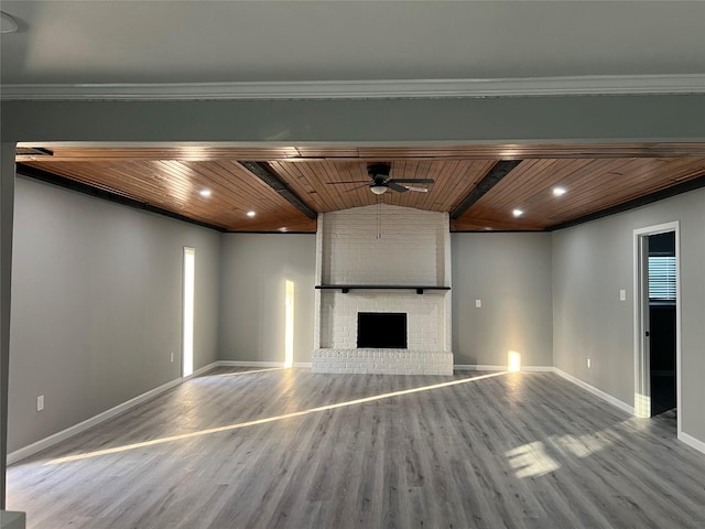 unfurnished living room with a fireplace, wood finished floors, and wood ceiling