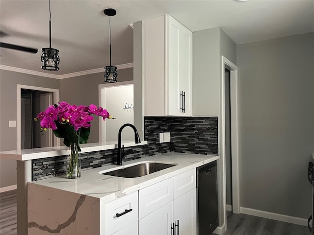 kitchen with decorative backsplash, white cabinets, wood finished floors, and a sink