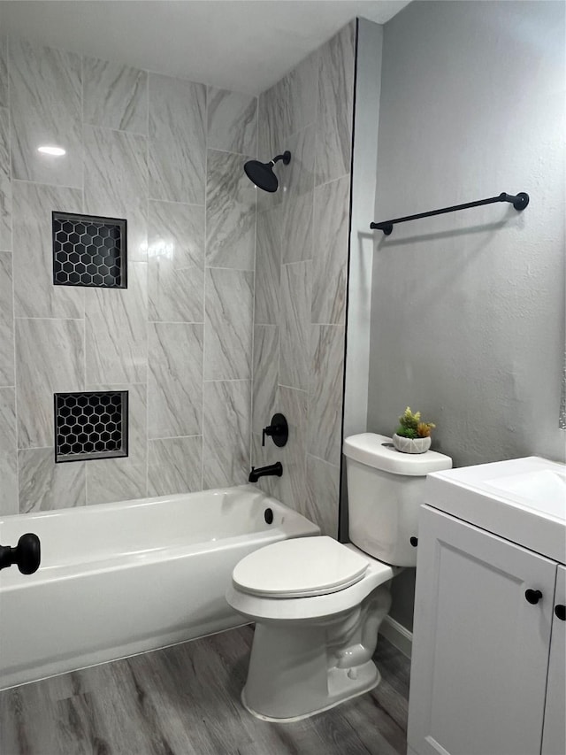 full bath featuring bathtub / shower combination, vanity, toilet, and wood finished floors