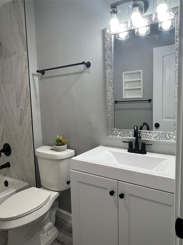 bathroom featuring vanity, an inviting chandelier, toilet, and washtub / shower combination