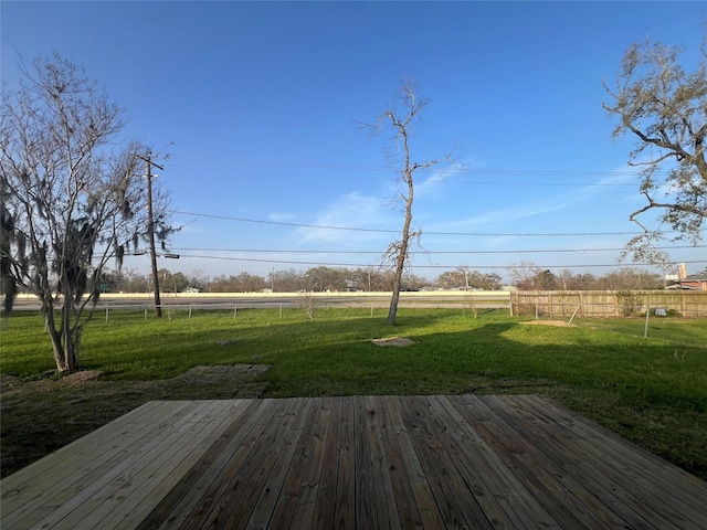 deck featuring a yard and fence