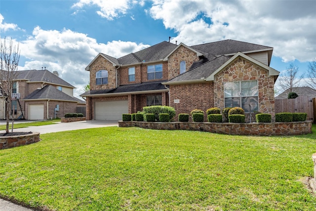 traditional-style home with driveway, stone siding, a front yard, an attached garage, and brick siding