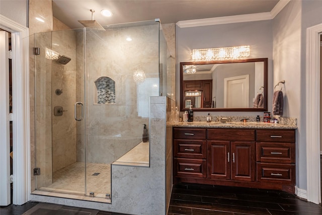 bathroom featuring vanity, crown molding, wood finished floors, and a shower stall