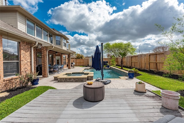 view of swimming pool featuring a patio area, a fenced backyard, and a wooden deck