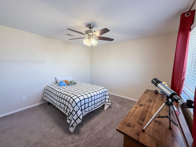 carpeted bedroom featuring visible vents, baseboards, multiple windows, and ceiling fan