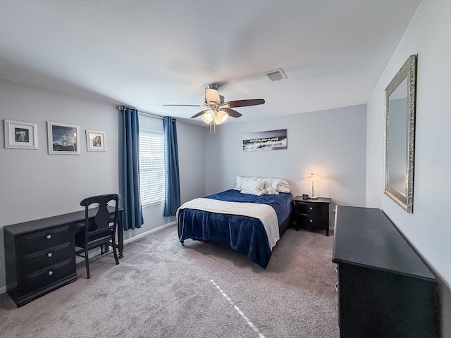 bedroom with visible vents, baseboards, carpet, and ceiling fan