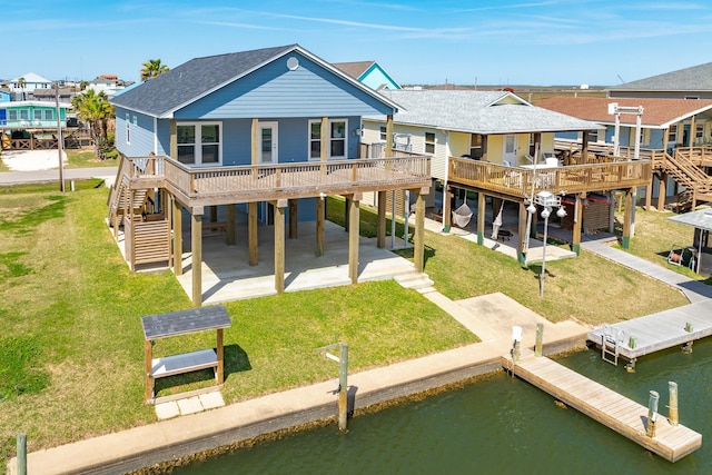 rear view of house featuring stairway, a water view, a carport, and roof with shingles