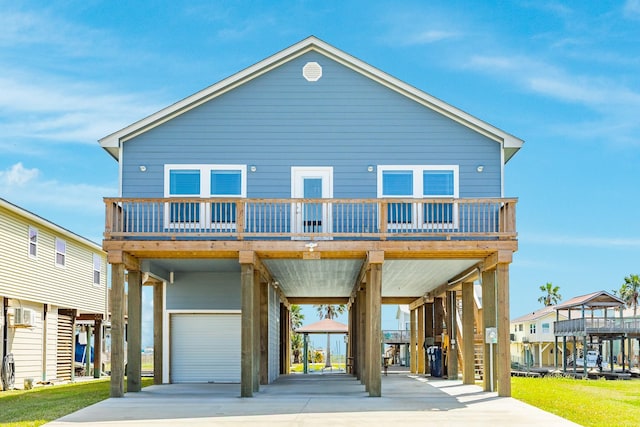 coastal home featuring a carport, an attached garage, and driveway