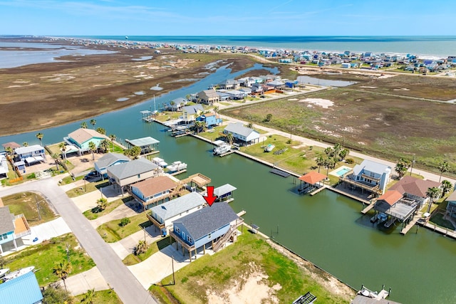 drone / aerial view featuring a residential view and a water view