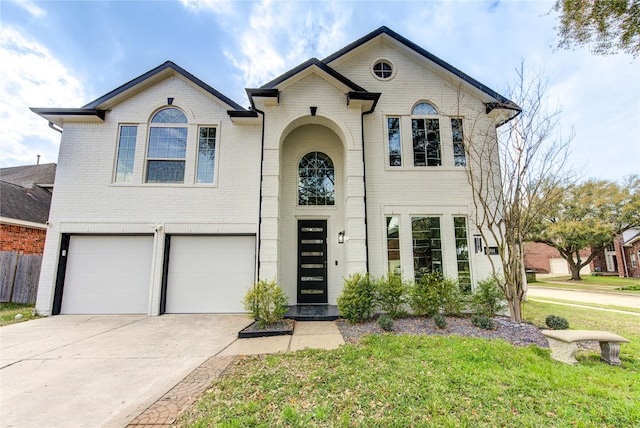 view of front of house featuring driveway, fence, a front yard, an attached garage, and brick siding