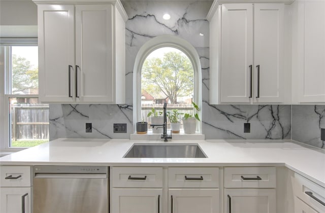 kitchen featuring white cabinets, light countertops, and stainless steel dishwasher