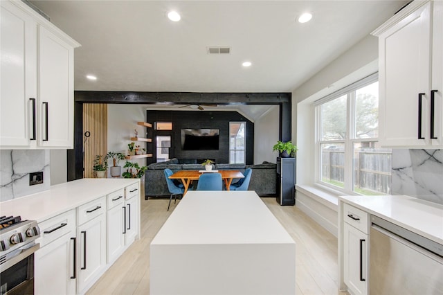 kitchen with tasteful backsplash, visible vents, light countertops, appliances with stainless steel finishes, and light wood-style floors