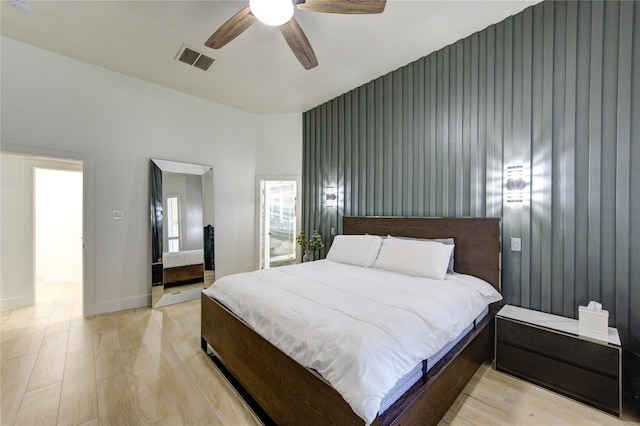 bedroom featuring baseboards, light wood-style floors, visible vents, and ceiling fan