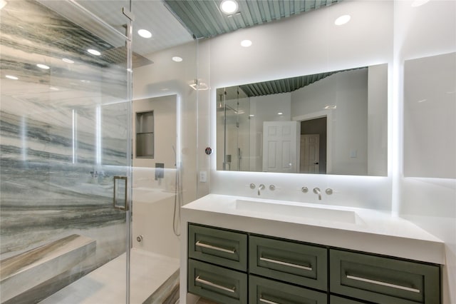 bathroom with recessed lighting, a shower stall, and vanity