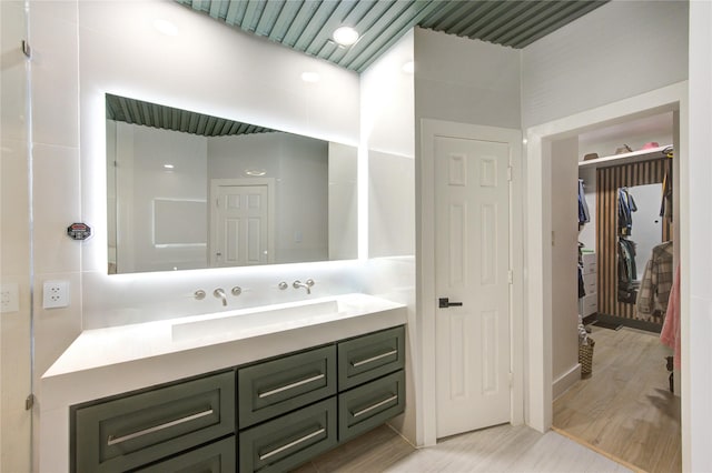 full bath featuring vanity and wood finished floors