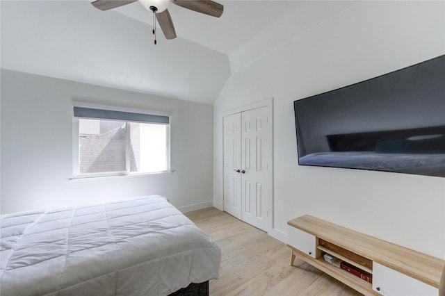 bedroom with wood finished floors, baseboards, lofted ceiling, ceiling fan, and a closet