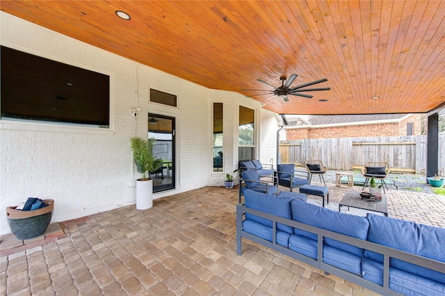 view of patio / terrace featuring a ceiling fan, an outdoor living space, and fence