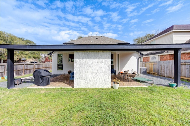 back of house featuring a yard, cooling unit, a fenced backyard, and a patio area