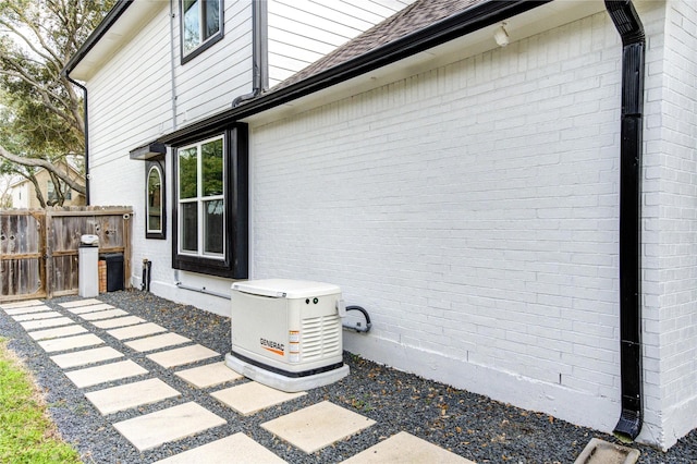 exterior space with brick siding and fence