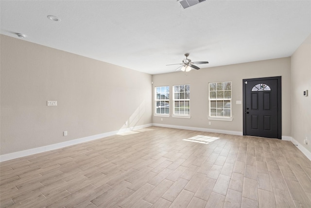 foyer with baseboards, visible vents, light wood-type flooring, and ceiling fan