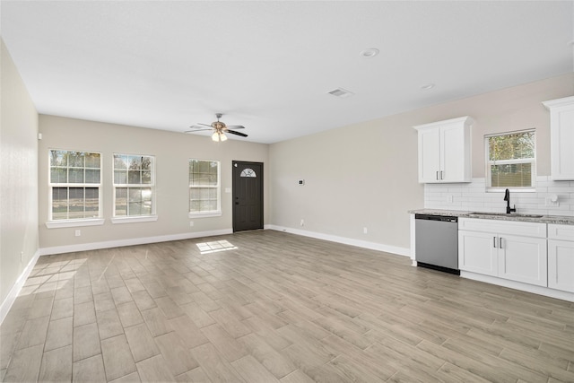 kitchen featuring a ceiling fan, visible vents, a sink, dishwasher, and backsplash