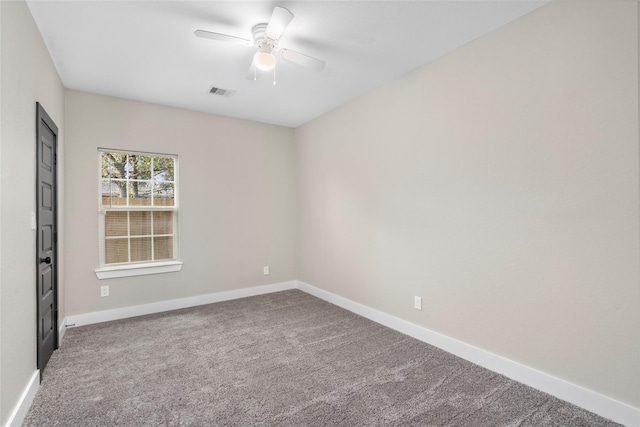 carpeted empty room with visible vents, ceiling fan, and baseboards