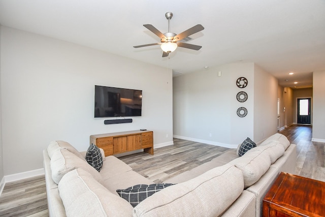 living room with recessed lighting, baseboards, a ceiling fan, and light wood finished floors