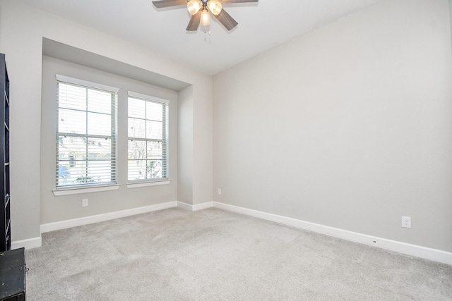 spare room featuring carpet flooring, baseboards, and a ceiling fan