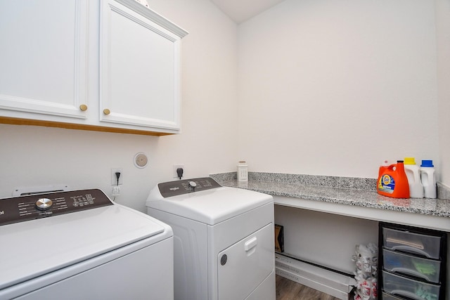 laundry area featuring cabinet space, independent washer and dryer, and wood finished floors