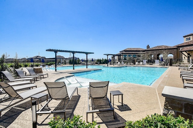 community pool featuring a patio area, a pergola, and fence