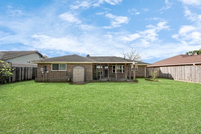 back of property featuring brick siding, a lawn, a patio, and a fenced backyard